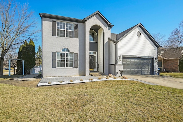 traditional-style house featuring a front lawn, a garage, brick siding, and driveway