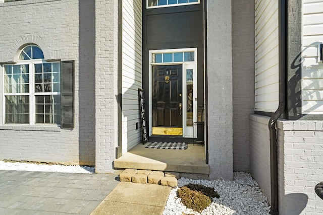 property entrance with brick siding