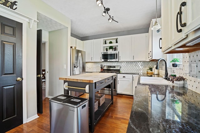 kitchen featuring a sink, open shelves, butcher block countertops, appliances with stainless steel finishes, and dark wood-style flooring