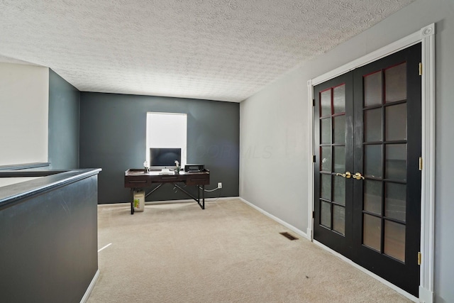 office space featuring visible vents, carpet flooring, french doors, and a textured ceiling