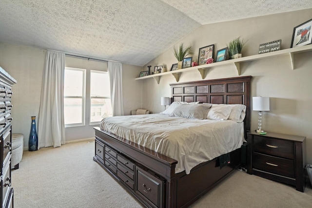 bedroom featuring light colored carpet, a textured ceiling, and lofted ceiling