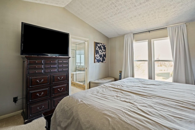 bedroom featuring connected bathroom, baseboards, lofted ceiling, light carpet, and a textured ceiling