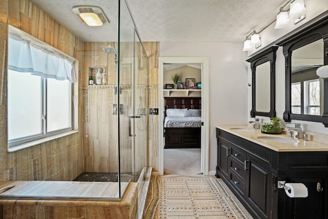 bathroom with ensuite bath, a shower stall, visible vents, and a sink