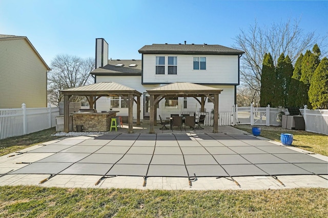 back of house featuring a gazebo, fence private yard, and a patio area