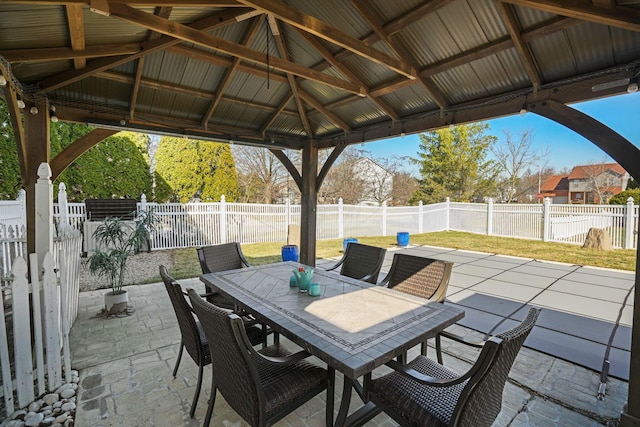 view of patio / terrace featuring outdoor dining space, a gazebo, and a fenced backyard