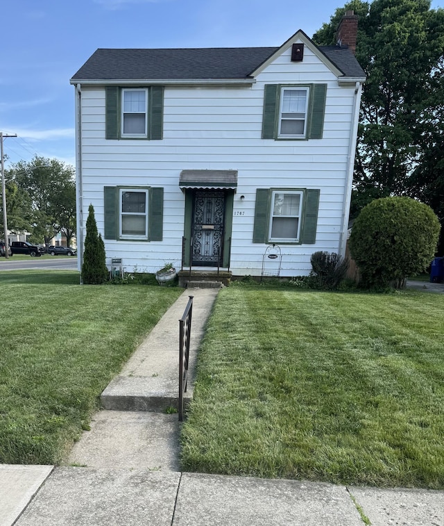 1767 Forest St, Columbus, OH 43206 - traditional home with a front lawn, a chimney, and a shingled roof