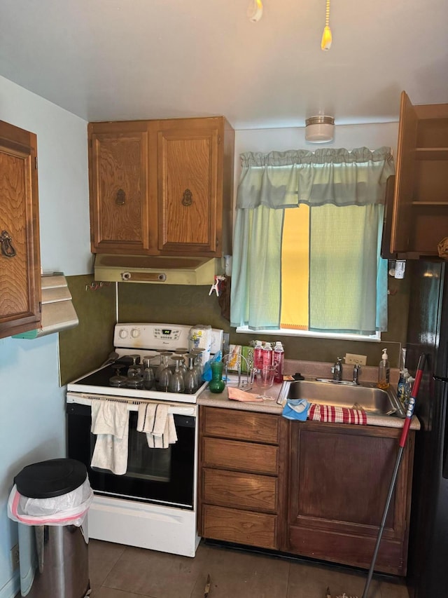 1767 Forest St, Columbus, OH 43206 - kitchen with range, under cabinet range hood, a sink, and tile patterned flooring