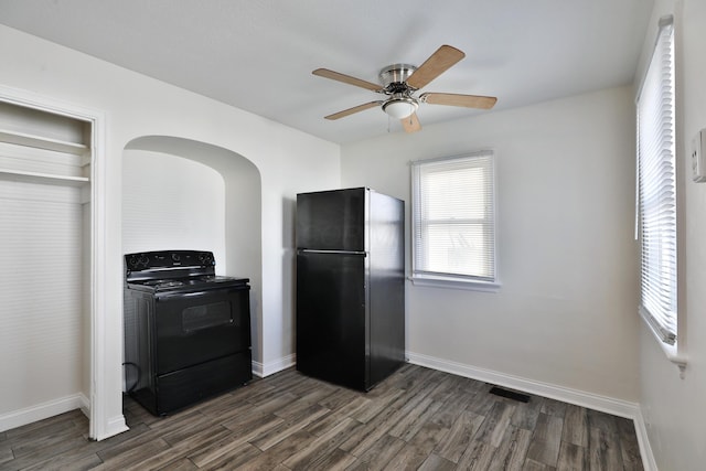 kitchen featuring black appliances, visible vents, dark wood-style flooring, and baseboards