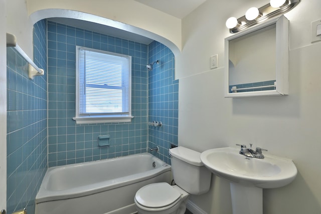 bathroom with a sink, toilet, and shower / bath combination