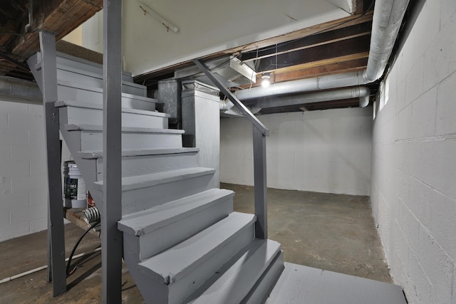 unfinished basement featuring stairway