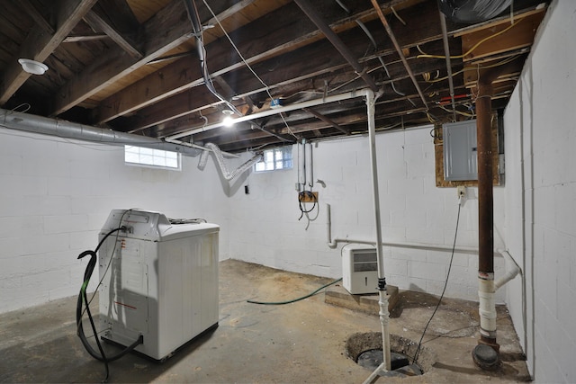 below grade area with electric panel and washer / clothes dryer