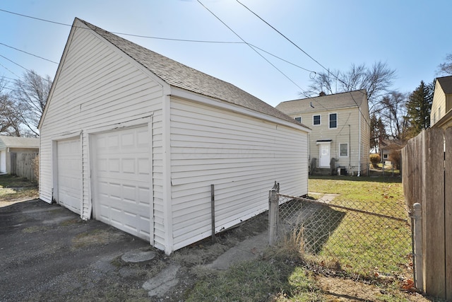 detached garage featuring fence