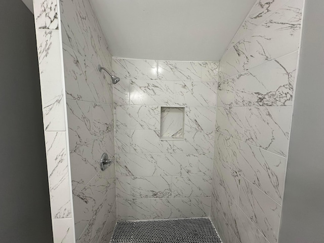 full bath with a tile shower