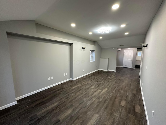 unfurnished room featuring recessed lighting, dark wood-type flooring, baseboards, and vaulted ceiling