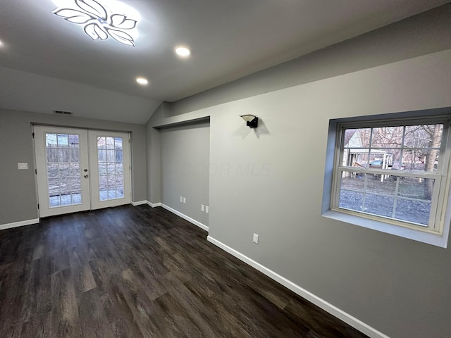 spare room with dark wood-style floors, french doors, visible vents, and baseboards