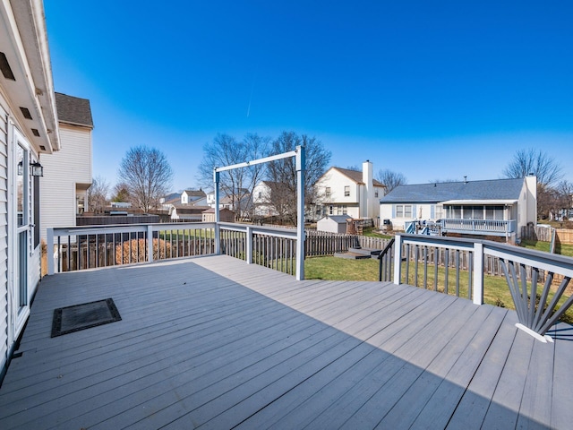 deck featuring a yard, a residential view, and a fenced backyard