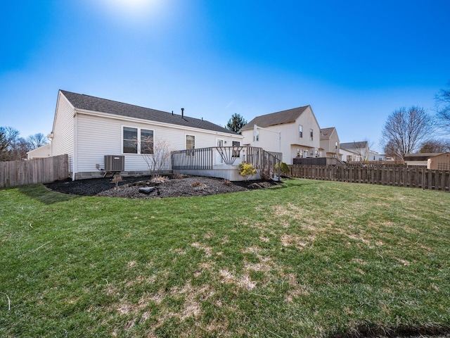 exterior space with a wooden deck, cooling unit, a yard, and a fenced backyard