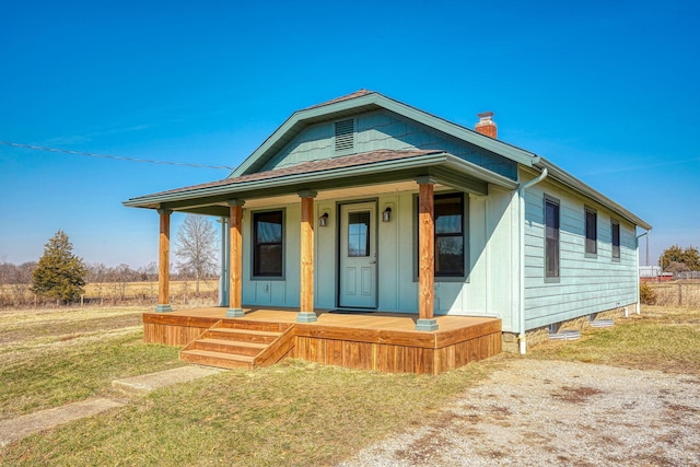 view of front of property featuring a porch and a chimney