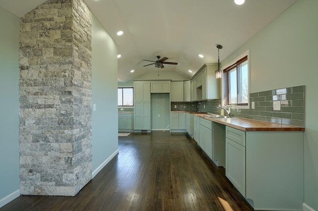 kitchen with tasteful backsplash, wooden counters, dark wood finished floors, lofted ceiling, and a wealth of natural light