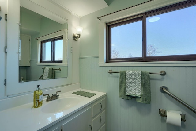 bathroom with a wainscoted wall and vanity