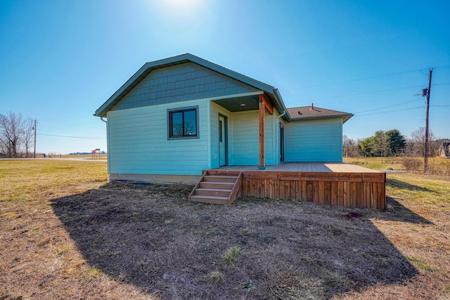 view of front of home featuring a deck and a front lawn