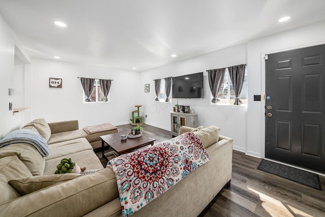 living room with recessed lighting, dark wood-type flooring, and baseboards