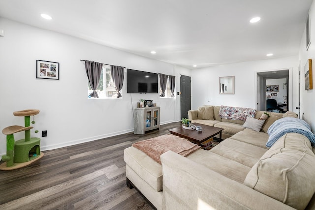 living room featuring recessed lighting, dark wood-style floors, and baseboards