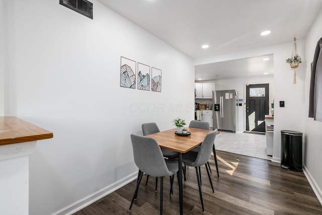 dining space with visible vents, recessed lighting, dark wood-style floors, and baseboards