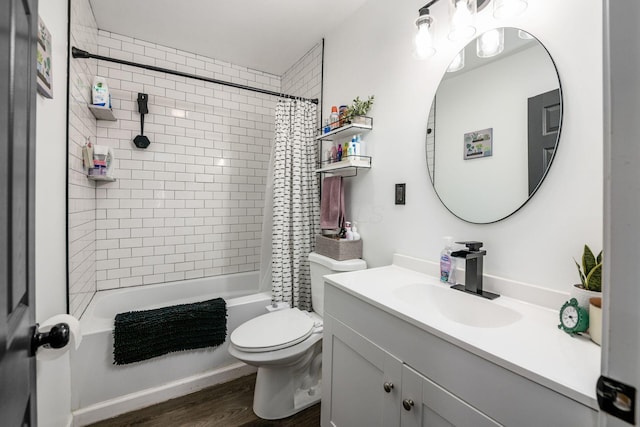 bathroom featuring shower / bathtub combination with curtain, toilet, wood finished floors, and vanity