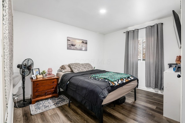 bedroom featuring baseboards and wood finished floors