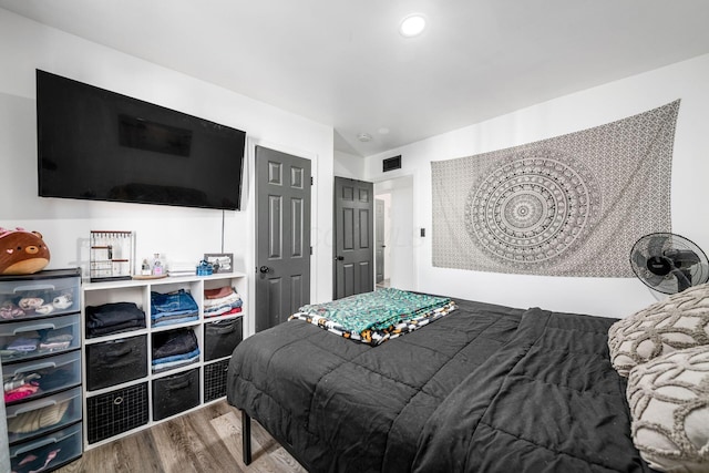 bedroom featuring recessed lighting and wood finished floors