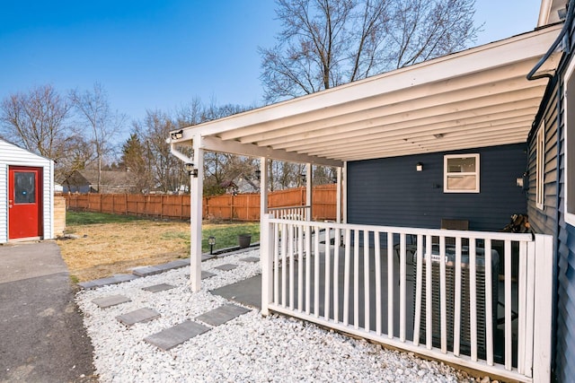 view of patio / terrace featuring an outdoor structure and fence