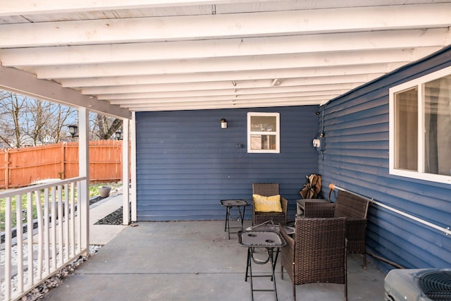 view of patio / terrace featuring central AC unit and fence