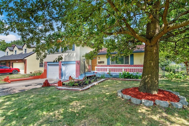 view of front of property featuring stucco siding, concrete driveway, an attached garage, a front yard, and brick siding