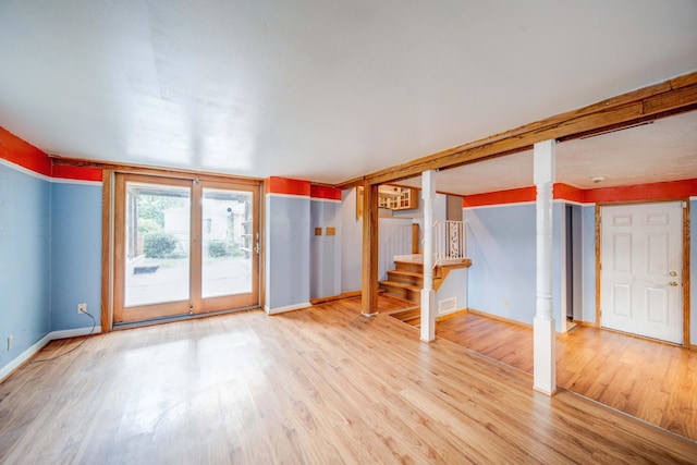 interior space featuring stairway, baseboards, and light wood-style floors