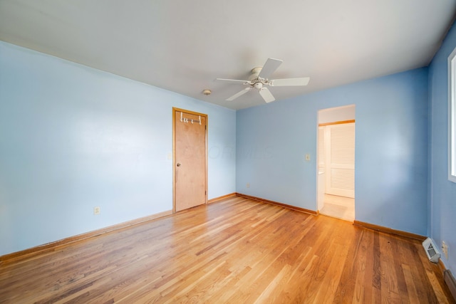 unfurnished room with visible vents, baseboards, light wood-type flooring, and ceiling fan