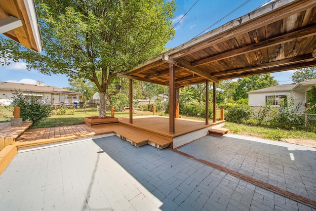 view of patio featuring a deck and fence