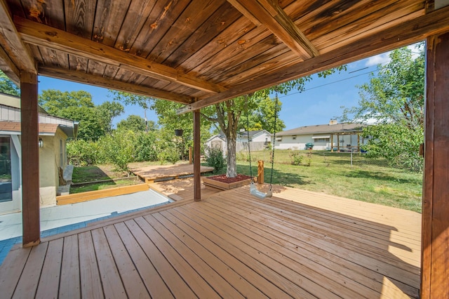 wooden terrace featuring a yard