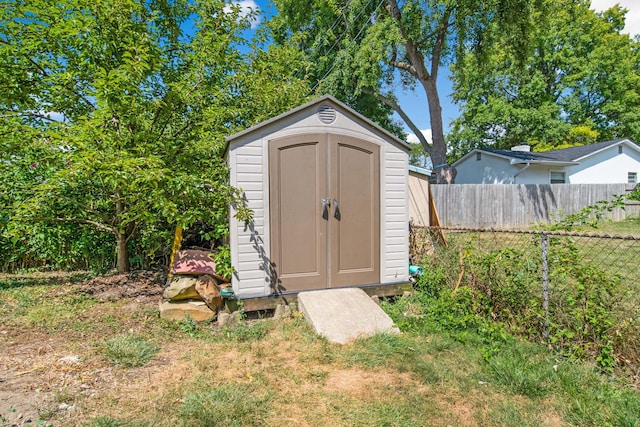 view of shed with fence