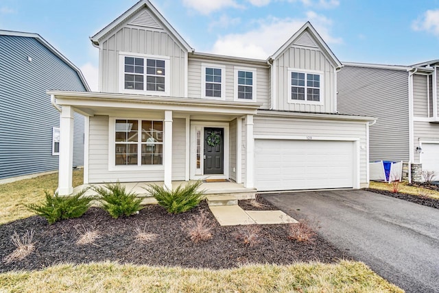 view of front of house featuring a garage, aphalt driveway, a porch, and board and batten siding