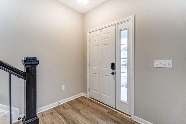 entrance foyer with baseboards and light wood-style floors