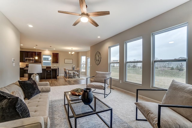 living area with recessed lighting, baseboards, and ceiling fan