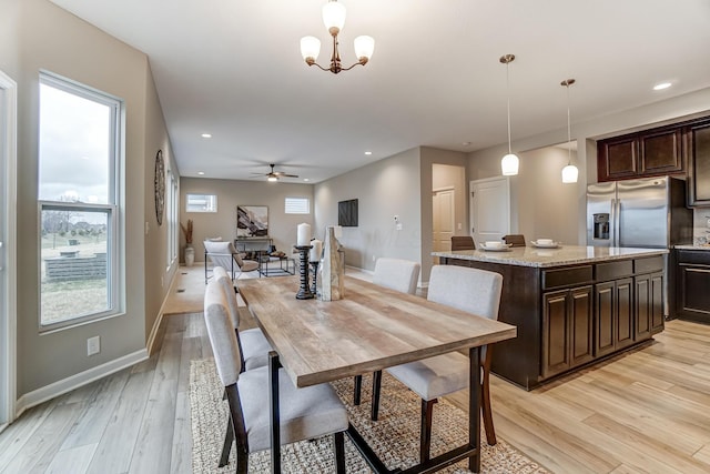 dining room featuring ceiling fan with notable chandelier, recessed lighting, baseboards, and light wood-style floors