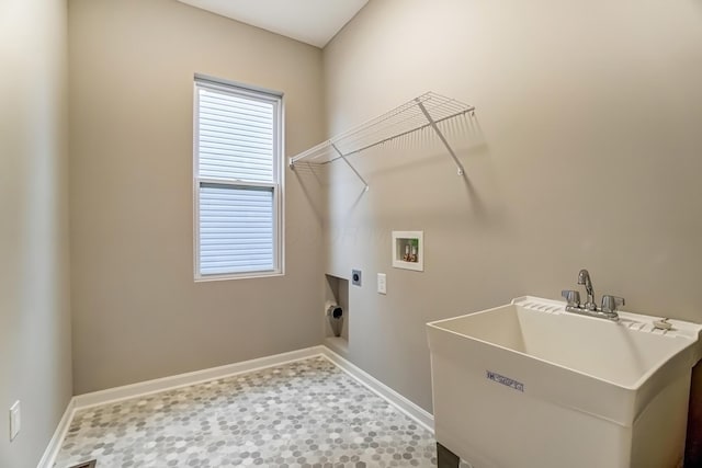 clothes washing area featuring baseboards, washer hookup, laundry area, electric dryer hookup, and a sink