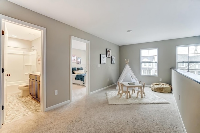 recreation room with light colored carpet and baseboards