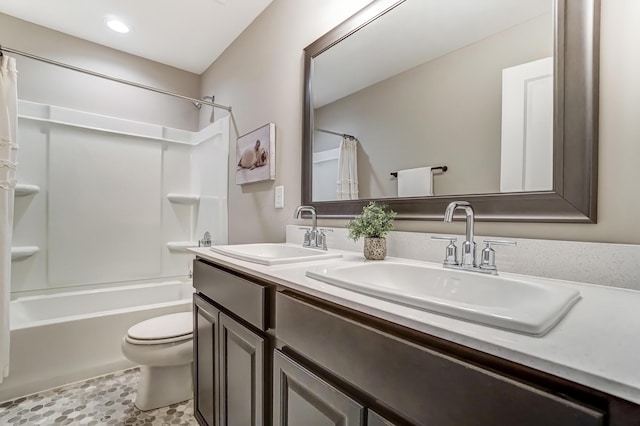 bathroom with double vanity, toilet, shower / tub combo with curtain, and a sink