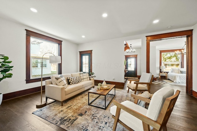 living area with recessed lighting, a healthy amount of sunlight, a chandelier, and hardwood / wood-style flooring