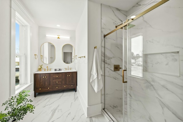 bathroom featuring a marble finish shower, marble finish floor, and a sink