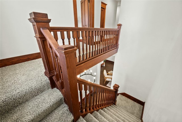 stairs featuring baseboards and carpet floors