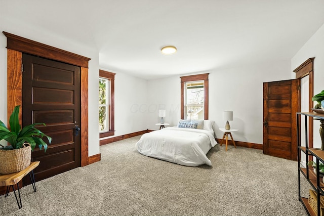 carpeted bedroom with baseboards